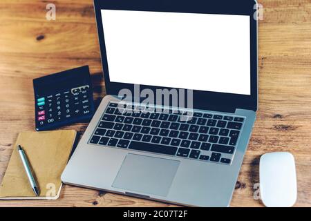 Close up Laptop Computer on Top of Office Table of a Businessman with Empty White Screen, Emphasizing Copy Space. Stock Photo