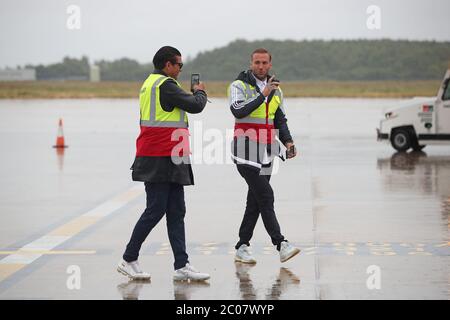 Calum Best (right) and Tamer Hassan pose for photographs as boxes of Personal Protection Equipment (PPE) are unloaded from a plane at Robin Hood Airport in Doncaster, South Yorkshire. ??30,000 worth of PPE has been donated to the Mask Our Heroes charity, which was set up by entrepreneur Matthew McGahan in the wake of the coronavirus outbreak to help supply frontline NHS and health workers with the protective equipment they need. Stock Photo