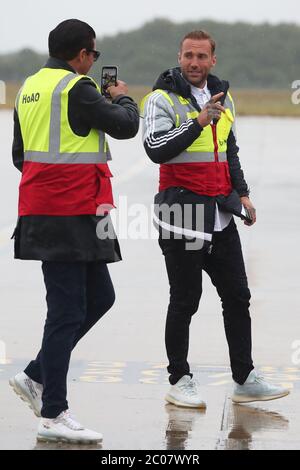 Calum Best (right) and Tamer Hassan pose for photographs as boxes of Personal Protection Equipment (PPE) are unloaded from a plane at Robin Hood Airport in Doncaster, South Yorkshire. ??30,000 worth of PPE has been donated to the Mask Our Heroes charity, which was set up by actor Tamer Hassan in the wake of the coronavirus outbreak to help supply frontline NHS and health workers with the protective equipment they need. Stock Photo