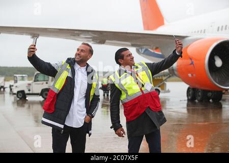 Calum Best (left) and Tamer Hassan pose for photographs as boxes of Personal Protection Equipment (PPE) are unloaded from a plane at Robin Hood Airport in Doncaster, South Yorkshire. ??30,000 worth of PPE has been donated to the Mask Our Heroes charity, which was set up by actor Tamer Hassan in the wake of the coronavirus outbreak to help supply frontline NHS and health workers with the protective equipment they need. Stock Photo