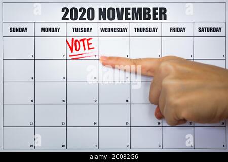 Vote now concept on a calander with a hand pointing at it. Stock Photo