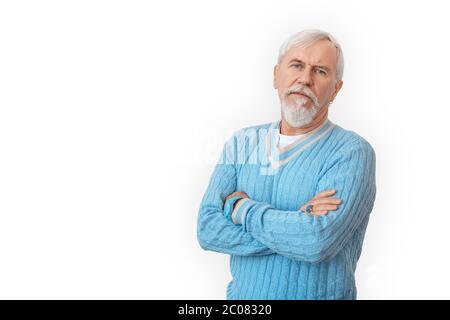 Freestyle. Senior bearded man in sweater standing isolated on white crossed arms pensive look Stock Photo