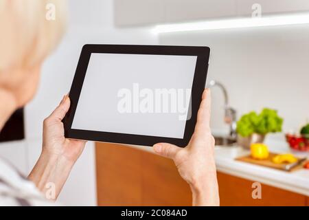 Elderly woman using modern tablet computer with copy space on display Stock Photo