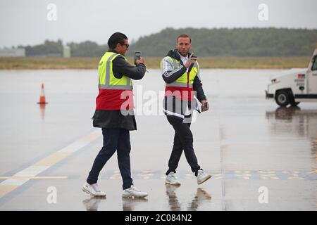 Calum Best (right) and Tamer Hassan pose for photographs as boxes of Personal Protection Equipment (PPE) are unloaded from a plane at Robin Hood Airport in Doncaster, South Yorkshire. ??30,000 worth of PPE has been donated to the Mask Our Heroes charity, which was set up by entrepreneur Matthew McGahan in the wake of the coronavirus outbreak to help supply frontline NHS and health workers with the protective equipment they need. Stock Photo