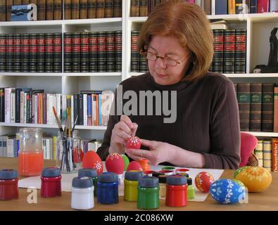woman painting Eggs for Easter decoration Stock Photo