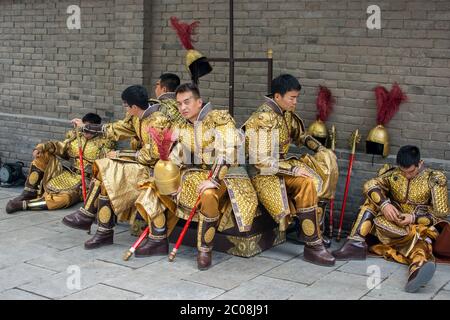 Xian / China - August 4th 2015: Group of men dressed as ancient Chinese Tang dynasty warriors in the Old walled city of Xian China Stock Photo