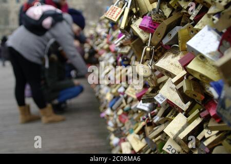 Symbol of love. Many padlocks hung on the railing of the bridge in Paris. A sign of romance, lovers. Stock Photo