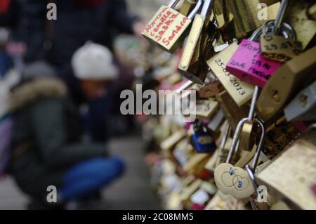 Symbol of love. Many padlocks hung on the railing of the bridge in Paris. A sign of romance, lovers. Stock Photo