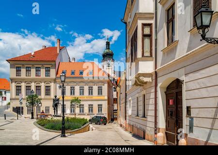 Cozy little baroque square in the center of Gyor, with the bronze sculpture of Nimrod, in the background the Cathedral tower.Hungary. Stock Photo