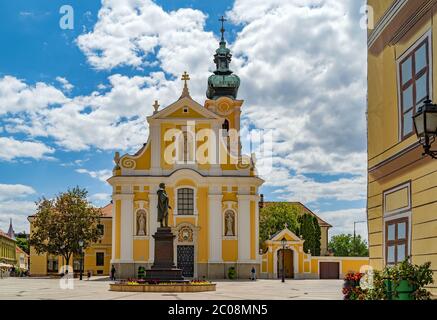 The Carmelite church and the sculpture of Kisfaludy at the Vienna's Gate Square in the downtown of Gyor,Hungary. Stock Photo