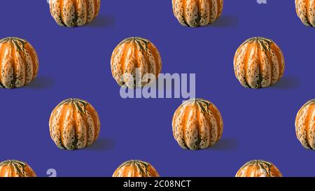 Seamless Pattern with with yellow pumpkin on purple background. Stock Photo
