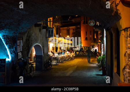 Late night in the village of Monterosso Al Mare, part of the Cinque Terre in Italy on the Italian Riviera as tourists enjoy an evening sidewalk cafe Stock Photo