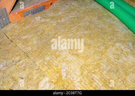 Ceiling and attic floor insulation made of rock wool between the trusses. Stock Photo