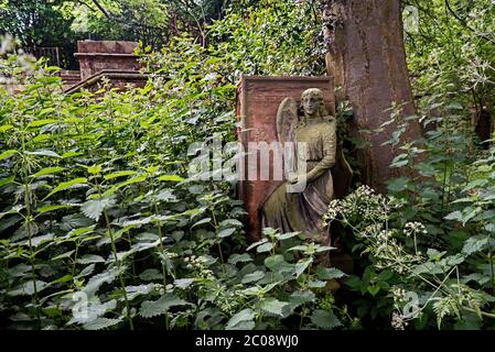 Memorial with angel in an overgrown and neglected Dalry Cemetery, Edinburgh, Scotland, UK. Stock Photo