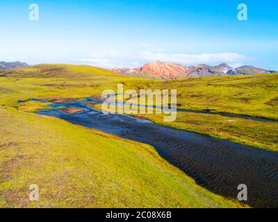 Green hilly landscape of Iceland Highlands with glacier river around Laugavegur hiking trail on sunny day, Iceland. Stock Photo