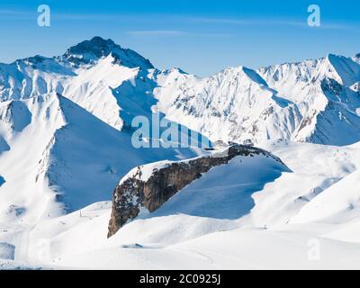 Sunny winter day in alpine ski resort with blue sky and bright white snow, Ischgl and Samnaun, Silvretta Arena, Austria - Switzerland Stock Photo