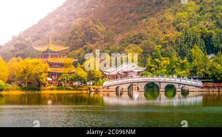 Suocui Bridge over Black Dragon Pool at Moon Embracing Pavilion in Jade Spring Park, Lijiang, China. Stock Photo