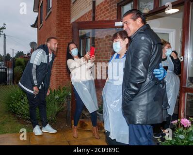 Calum Best (left) and Tamer Hassan (right), with care assistants Maria Lawson (second left) and Pauline Cod (third left), outside the The Royal care home in Rossington, after dropping off a box of Personal Protection Equipment (PPE), that was delivered by plane to Robin Hood Airport in Doncaster, South Yorkshire. ??30,000 worth of PPE has been donated to the Mask Our Heroes charity, which was set up by entrepreneur Matthew McGahan in the wake of the coronavirus outbreak to help supply frontline NHS and health workers with the protective equipment they need. Stock Photo