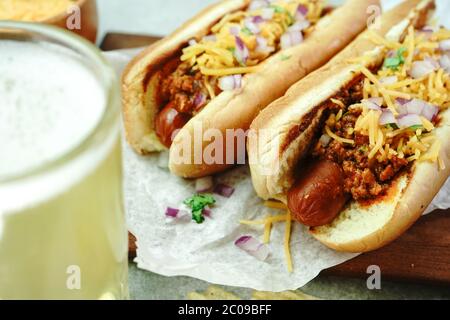 Homemade Chili dogs topped with cheddar cheese, selective focus Stock Photo