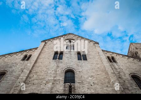 White stone cathedral close up with blue sky and small white clouds on the background Stock Photo