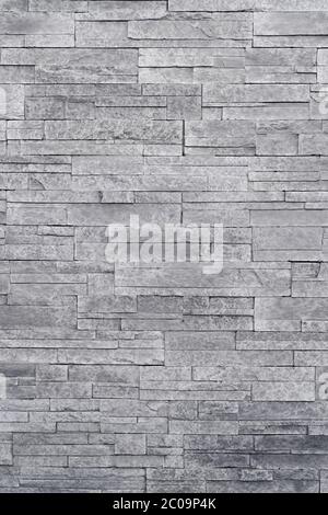 Stone veneer tiles stacked flat make beautiful & modern accent walls in interior design. Use this gray texture as wallpaper, background, backdrop... Stock Photo