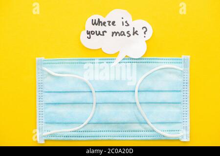 top view of medical mask with speech bubble on yellow background Stock Photo