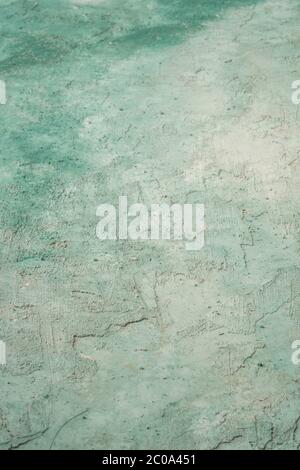 green and white painted grungy rough stucco wall background Stock Photo