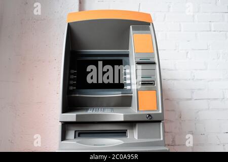 Automated teller machine with blank screen near white brick wall Stock Photo