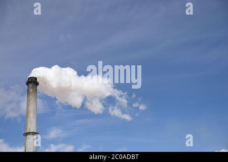 Sugar Mill, single smoke stack and emissions, blue sky and clouds in Nebraska, USA Stock Photo
