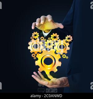 businessman showing gears cogs to success concept Stock Photo