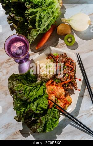 Korean beef bulgogi ssambap lettuce wraps with spicy kimchi and gochujang hot sauce Stock Photo