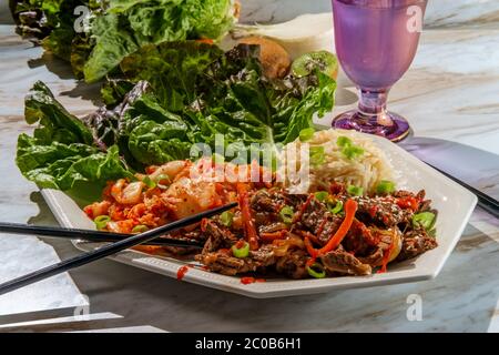 Korean beef bulgogi ssambap lettuce wraps with spicy kimchi and gochujang hot sauce Stock Photo