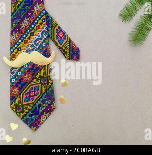 Father's day concept - hipster colorful tie, mustache, heart on wood background Stock Photo