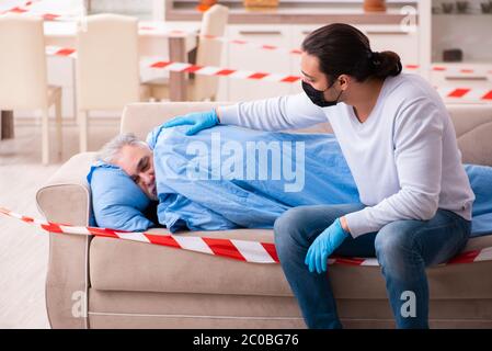 Father and son in the coronavirus concept at home Stock Photo
