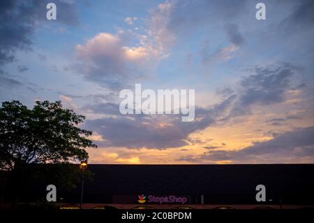 beautiful summer sunset coloring the clouds above grocery store in New Jersey USA Stock Photo