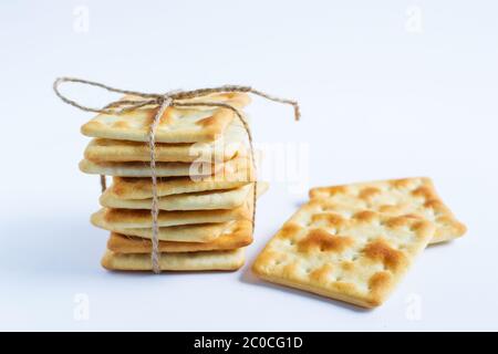 Square cookies tied with twine isolated on a white background. Healthy food. A snack on the way. Stock Photo