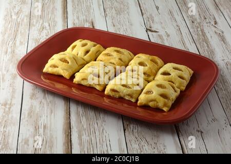 Mini apple strudel pastries on red breakfast brunch platter tray Stock Photo