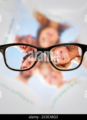 Composite image of happy volunteers forming a huddle against blue sky Stock Photo