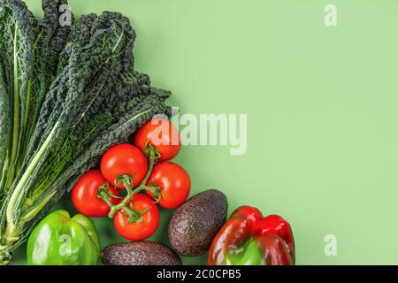 Vegetable creative layout on green background. Flat lay, copy space Stock Photo