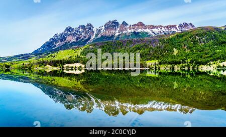 Reflection of Yellowhead Mountain on the smooth water surface of Yellowhead Lake in Robson Provincial Park in British Columbia, Canada Stock Photo