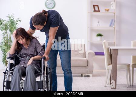 Disabled wife and husband at home Stock Photo