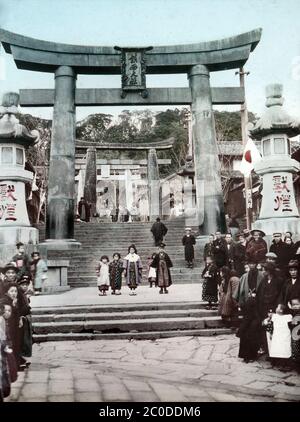 [ 1900s Japan - Suwa Jinja ] — Sacred torii gate at Suwa Jinja, an important Shinto shrine on the slopes of Mount Tamazono in Nagasaki.  Nagasaki’s best known religious festival, Nagasaki Kunchi, is held here. Authorities used the festival to discover Christians after the religion was banned early in the Edo Period (1603-1868).  20th century vintage glass slide. Stock Photo