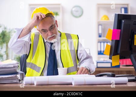 Old male architect working in office Stock Photo