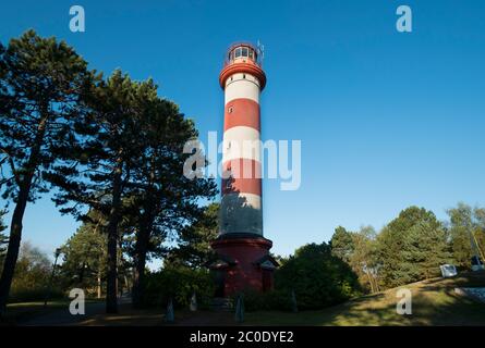 The iconic, white and red striped old lighthouse near Nida on the Curonian Spit on the Baltic Sea in  Lithuania. Stock Photo