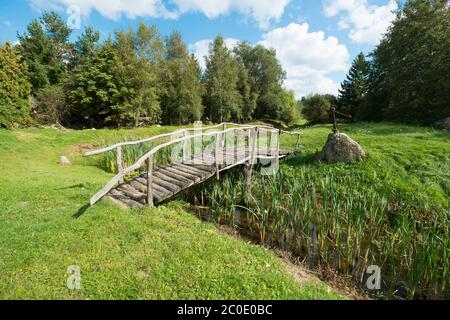 Makeshift wooden bridge over water Stock Photo - Alamy