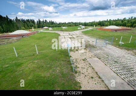 An overivew of the four missile silo caps in a field. At the Cold War Museum in Plokštinė, Lithuania. Stock Photo