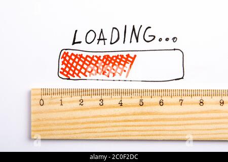 LOADING. Development, technology, software and apps concept. Wooden liner on a white background Stock Photo