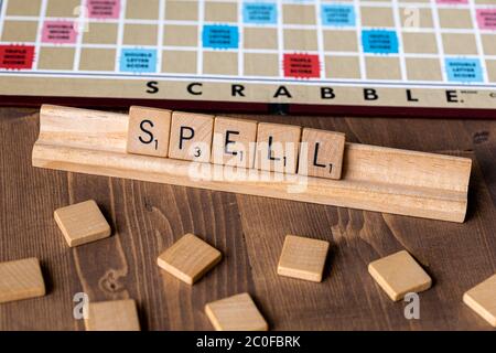 Scrabble board game with the scrabble tile spelling 'Spell' on table top Stock Photo
