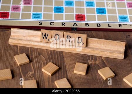 Scrabble board game with the scrabble tile spelling 'Word' on table top Stock Photo