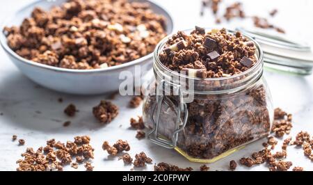 Jar of muesli with dark and milk cocolate pieces - closeup Stock Photo